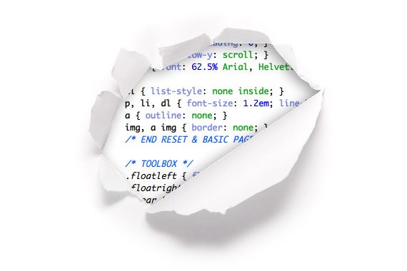 A sheet of paper torn open to reveal lines of CSS code underneath